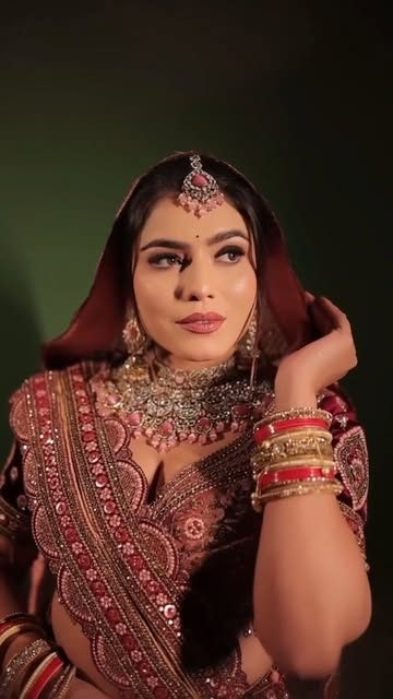 Bride in red lehenga with HD bridal makeup and maang tikka