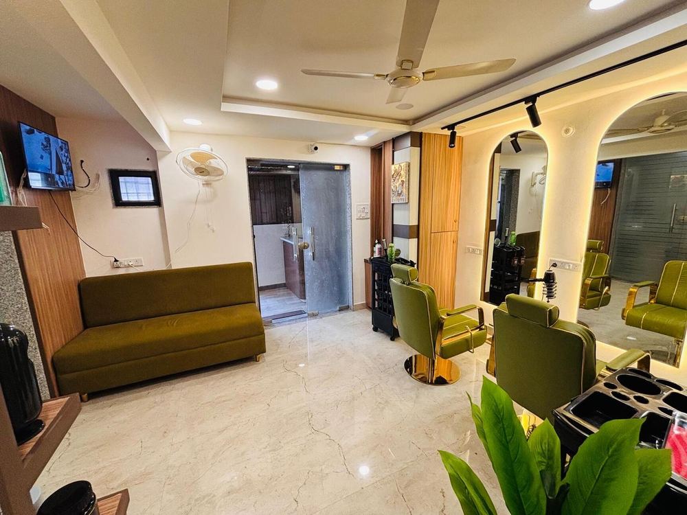 Salon floor with olive chairs, arched mirrors and a waiting sofa