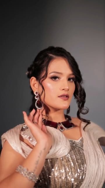 Party makeup with soft curls and silver embellished outfit
