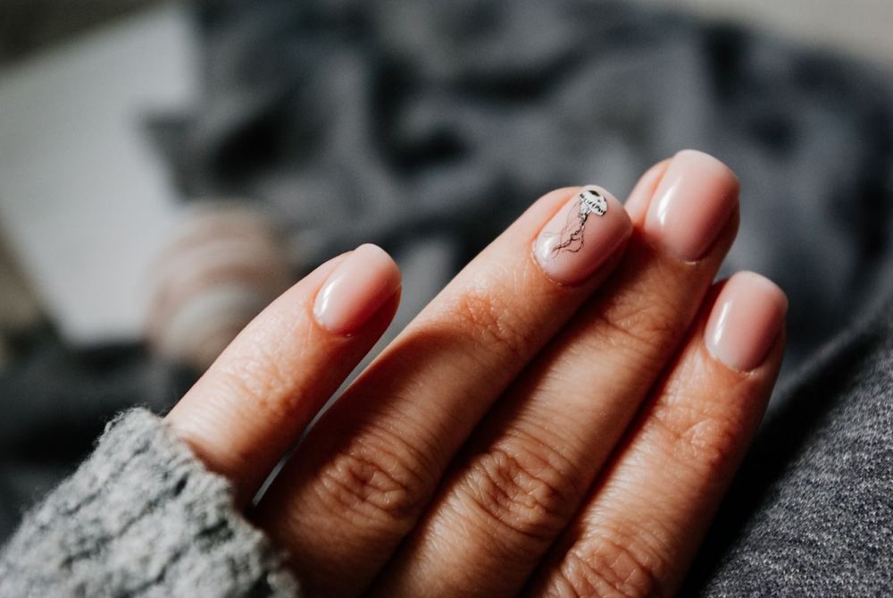 Hands with glossy nude nail art