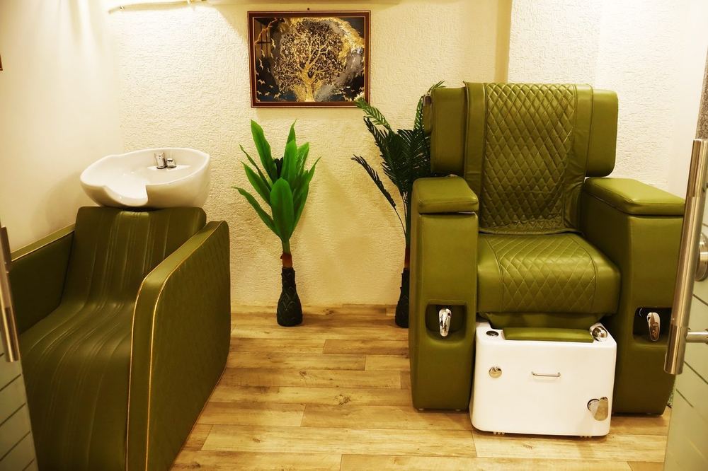 Hair wash station and spa chair beside a plant